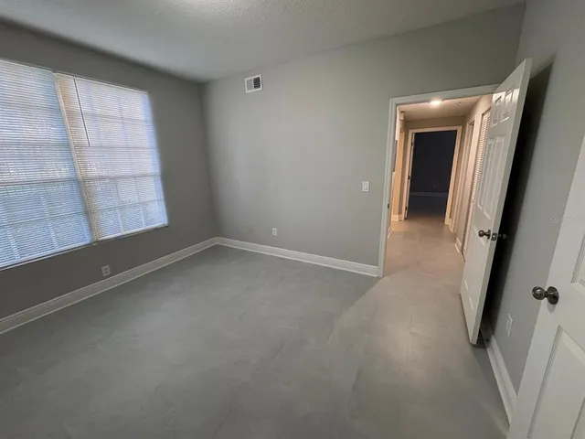 an empty room with windows and entrance