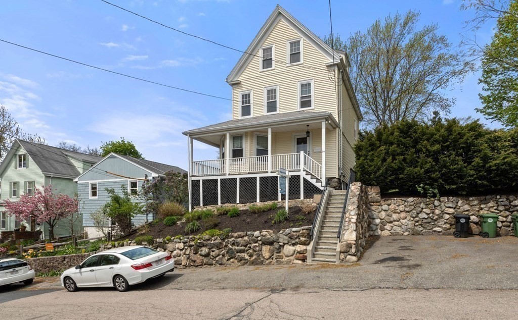 a front view of a house with a garden