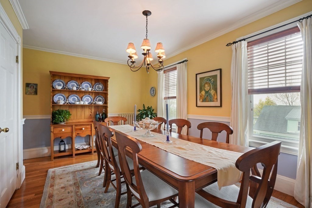 54 Olney Street Watertown, MA 02472 - Photo 14 of 28 a dining room with furniture a window and a chandelier
