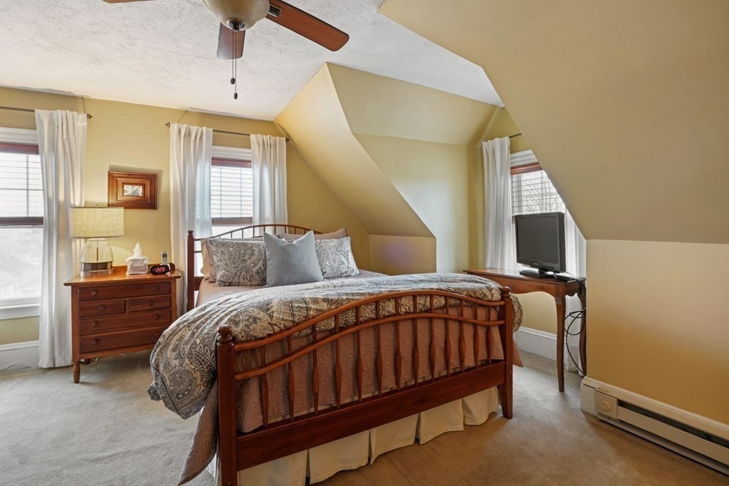 54 Olney Street Watertown, MA 02472 - Photo 17 of 28 a bed sitting in a bedroom next to a window