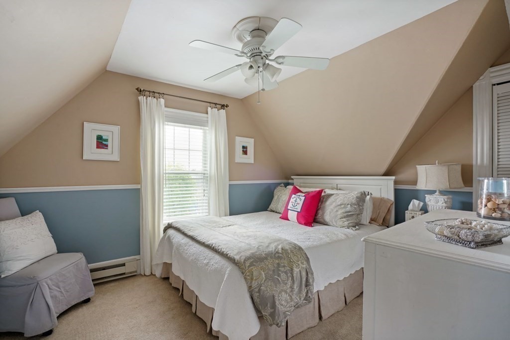 54 Olney Street Watertown, MA 02472 - Photo 18 of 28 a bedroom with a bed and a chandelier