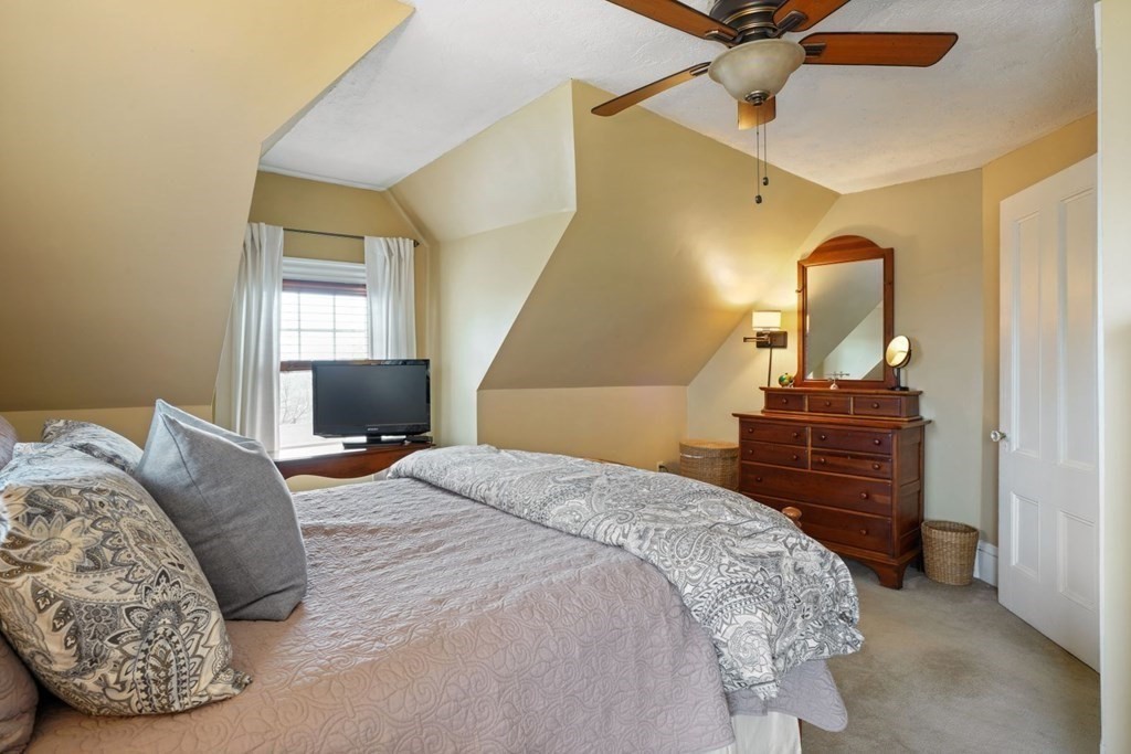 54 Olney Street Watertown, MA 02472 - Photo 19 of 28 a bedroom with a bed and wooden floor