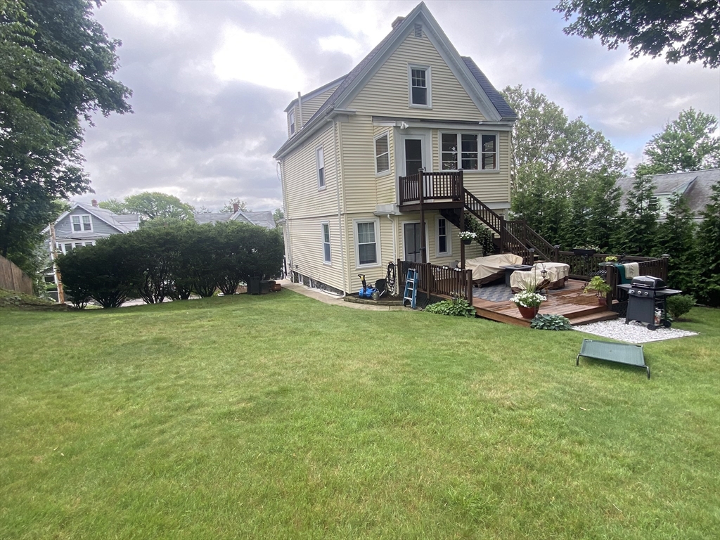 54 Olney Street Watertown, MA 02472 - Photo 23 of 28 a view of a house with a big yard plants and large trees