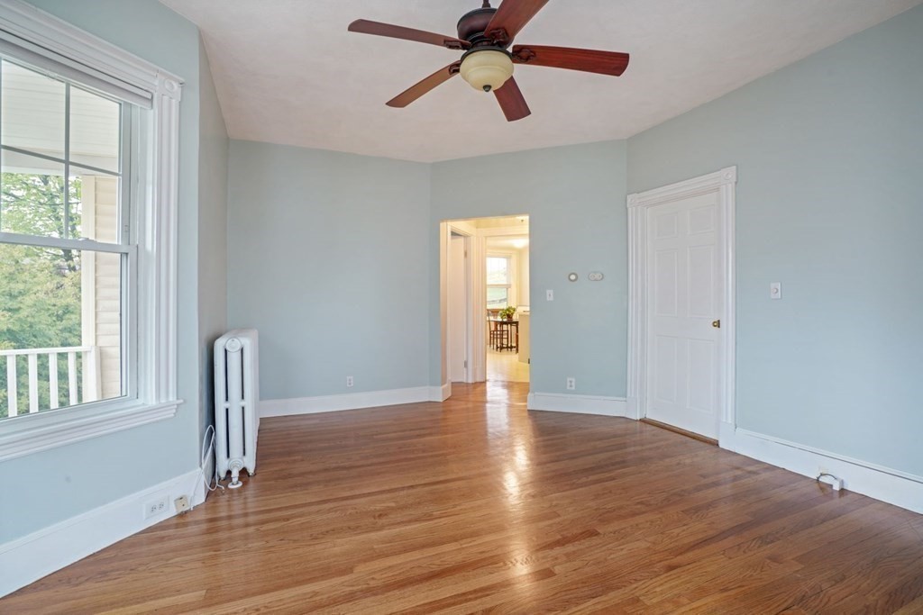 54 Olney Street Watertown, MA 02472 - Photo 7 of 28 a view of empty room with wooden floor and fan