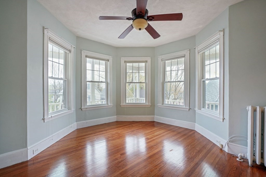 54 Olney Street Watertown, MA 02472 - Photo 8 of 28 a view of empty room with wooden floor and fan