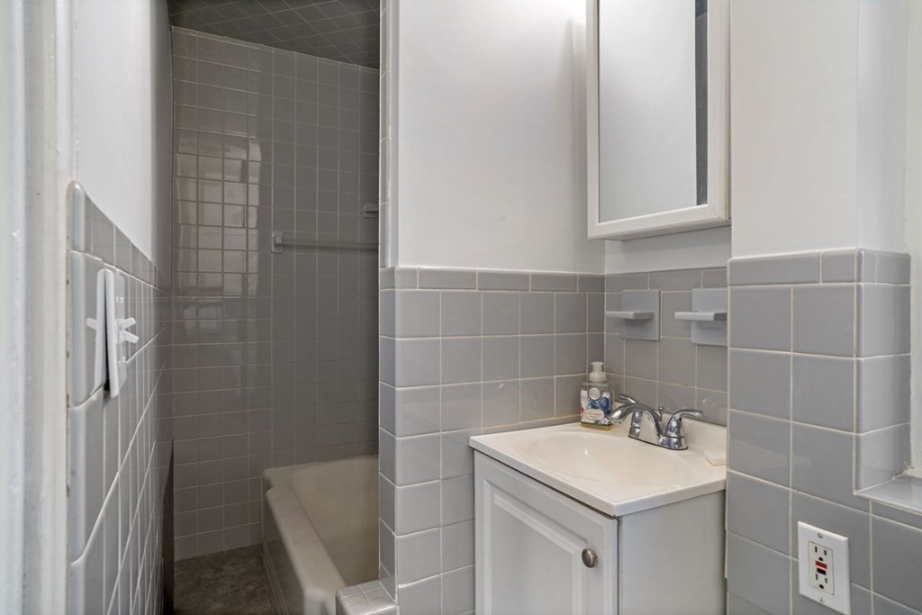 54 Olney Street Watertown, MA 02472 - Photo 10 of 28 a bathroom with a sink toilet and shower