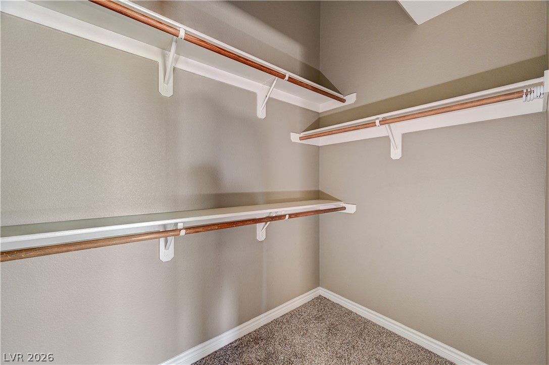 8985 South Durango Drive, Unit 2187 Las Vegas, NV 89113 - Photo 35 of 73 Ample shelving and hanging space offer organized storage in this well-appointed closet.