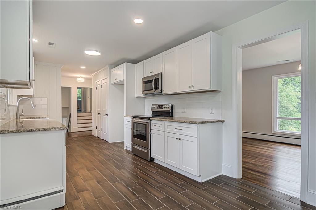 415 Kyle Road Winston-Salem, NC 27104 - Photo 11 of 37 Kitchen with new cabinets and tile floor
