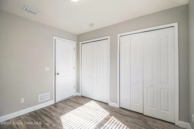a view of a room with wooden floor and closet