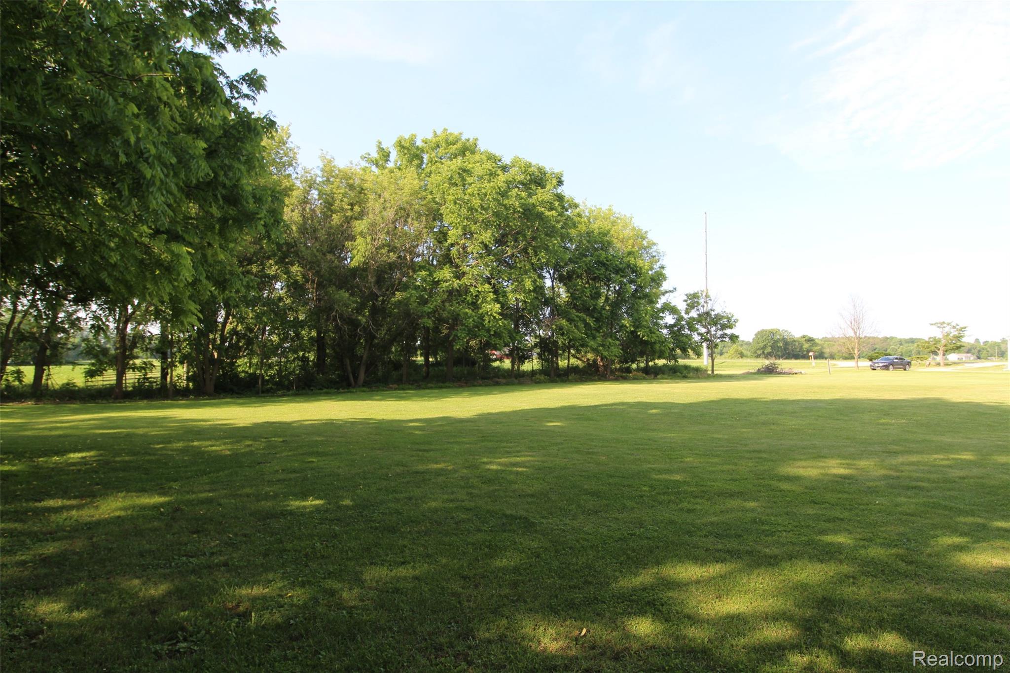 2568 Valentine Road Lapeer, MI 48446 - Photo 36 of 42 Expansive grounds featuring a manicured lawn with mature shade trees providing natural canopy coverage throughout the property