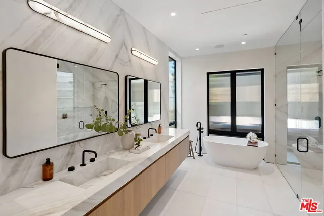 a spacious bathroom with double vanity sinks and a large mirror