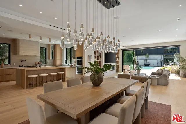 a view of a dining room kitchen with furniture and chandelier
