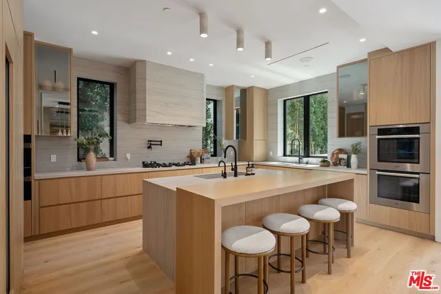 a kitchen with sink cabinets and dining table