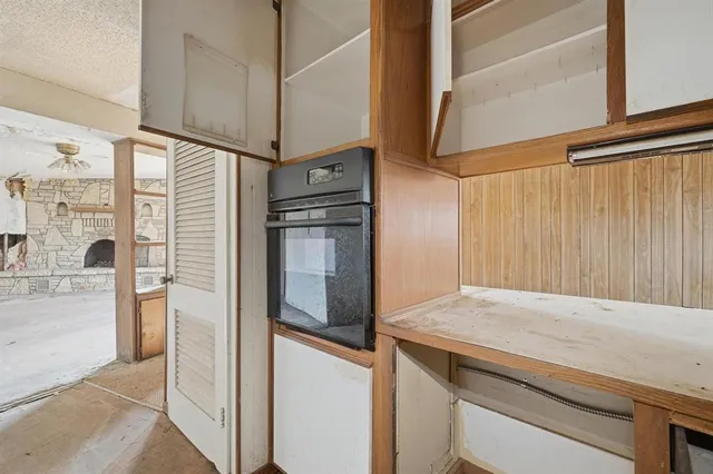 a bathroom with a granite countertop sink and washing machine