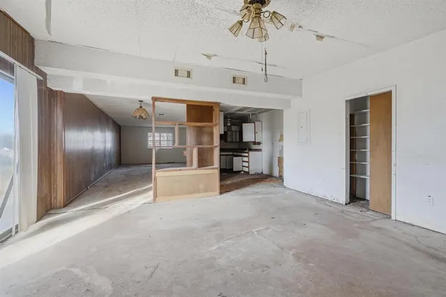 a view of a livingroom with a furniture staircase and windows