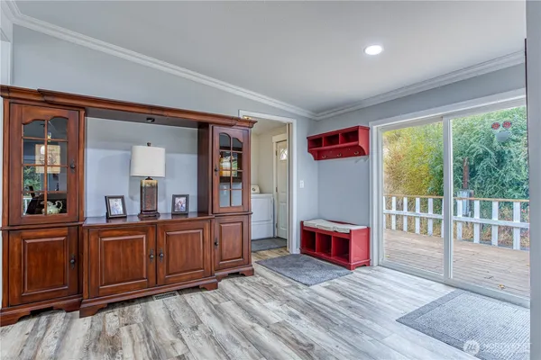 a living room with furniture cabinets and wooden floor
