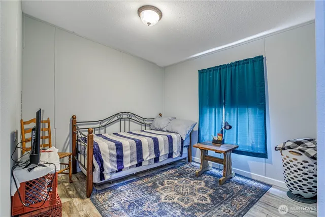 a bedroom with furniture and a rug