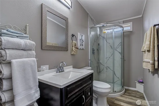a bathroom with a sink toilet and shower