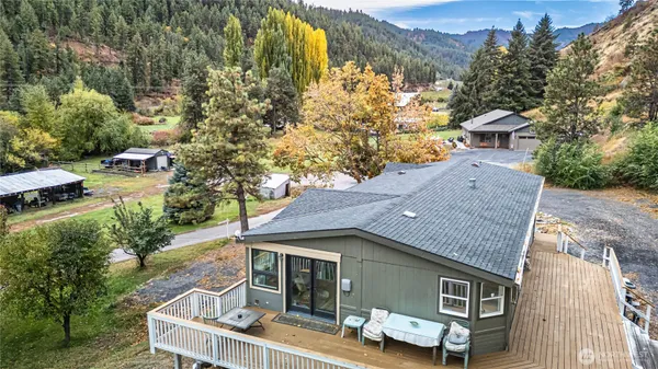 an aerial view of a house with a yard basket ball court and outdoor seating