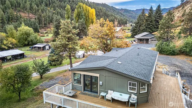 an aerial view of a house with a yard basket ball court and outdoor seating