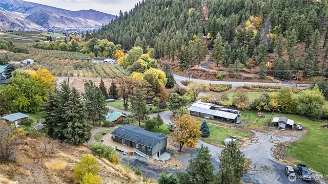 an aerial view of a house with garden space and sitting area