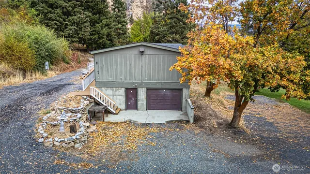 a backyard of a house with barbeque oven table and chairs