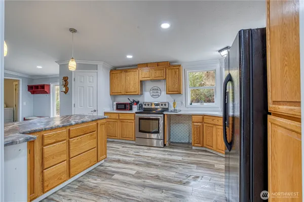 a kitchen with stainless steel appliances granite countertop a stove a sink and a refrigerator