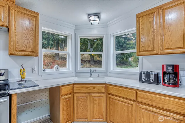 a kitchen with stainless steel appliances sink refrigerator and window