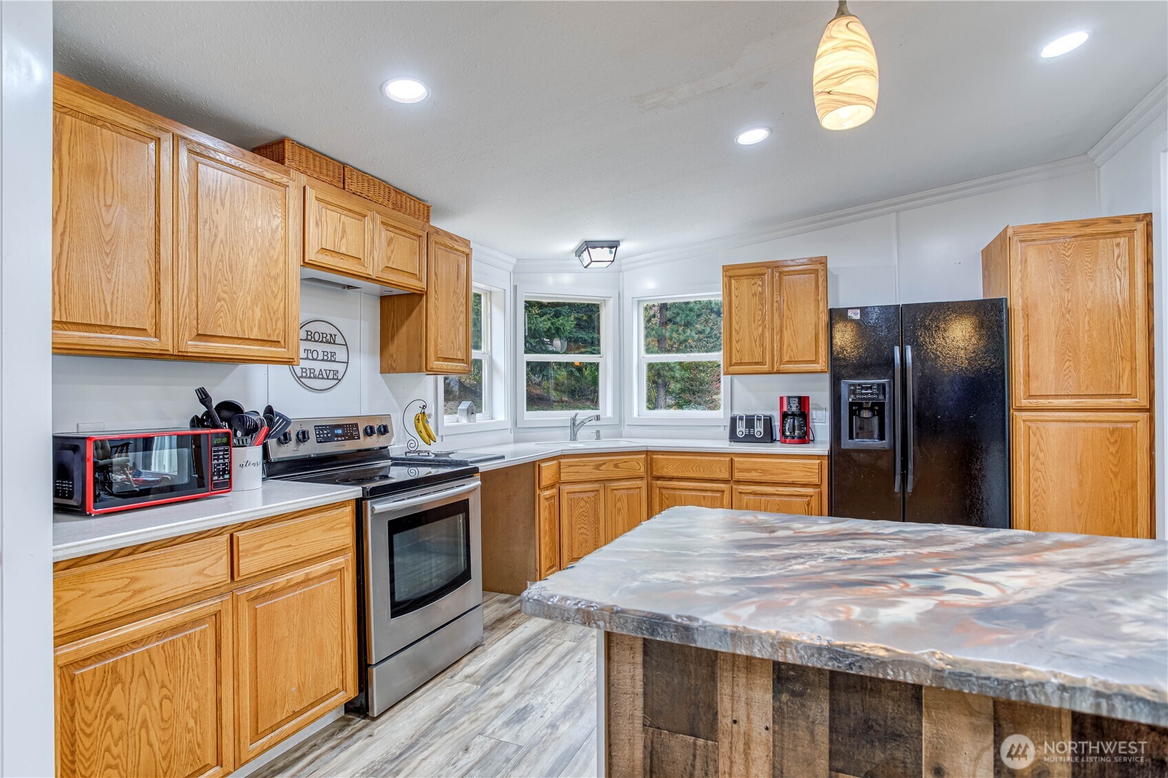 65 Sandstone Lane Cashmere, WA 98815 - Photo 7 of 39 a kitchen with stainless steel appliances granite countertop a stove a sink dishwasher a refrigerator and cabinets with wooden floor