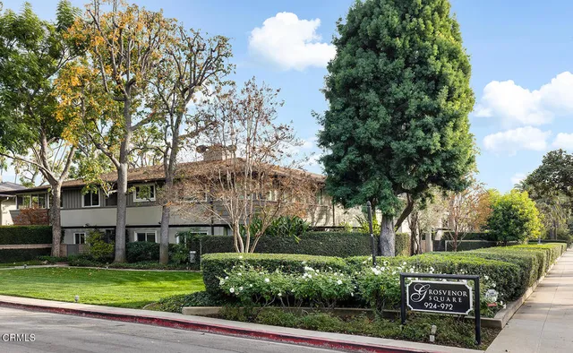 a front view of a building with trees