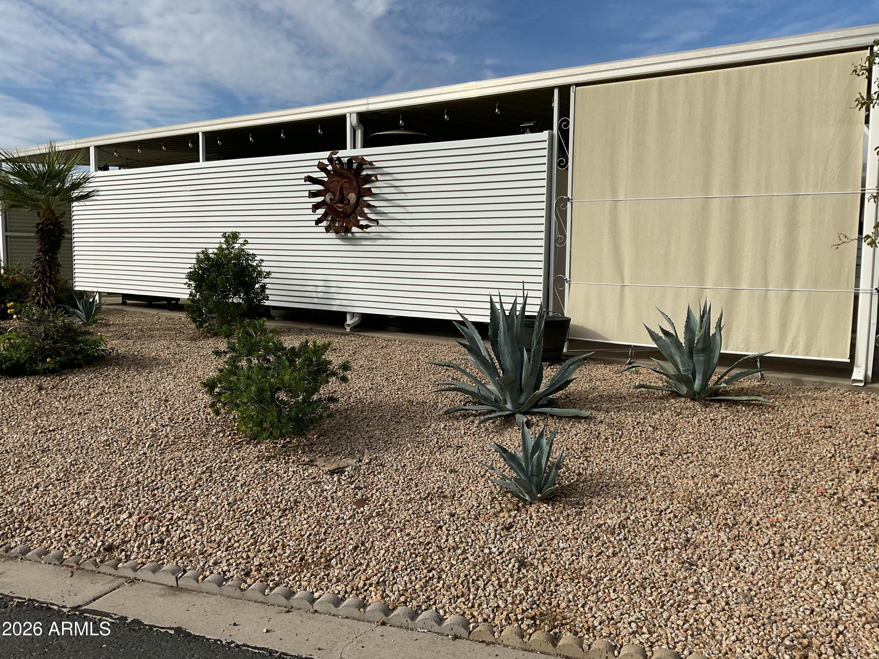 17200 West Bell Road, Unit 170 Surprise, AZ 85374 - Photo 10 of 39 a potted plant sitting in front of a house