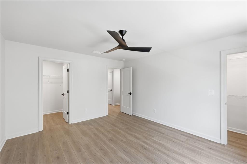 1121 Riverside Terrace Gainesville, GA 30501 - Photo 26 of 39 a view of a livingroom with wooden floor and a ceiling fan