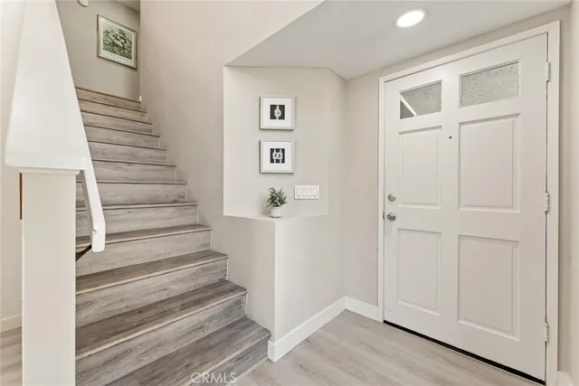 a view of a hallway with wooden floor and entryway
