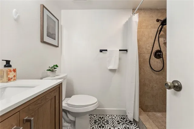 a bathroom with a sink toilet and shower