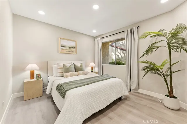 a bedroom with a bed and a painting on the wall