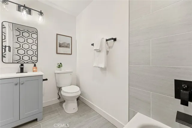 a white toilet sitting next to a bathroom sink