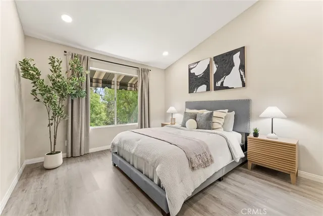 a bedroom with a large bed and a large window