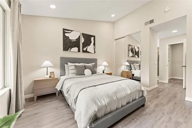 a bedroom with a bed and a painting