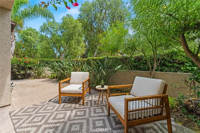 an outdoor sitting area with furniture and wooden floor