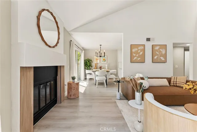 a living room with furniture a mirror and a fireplace