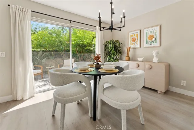 a dining room with furniture a chandelier and wooden floor