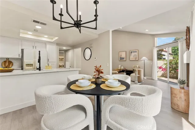 a view of a dining room with furniture and a chandelier