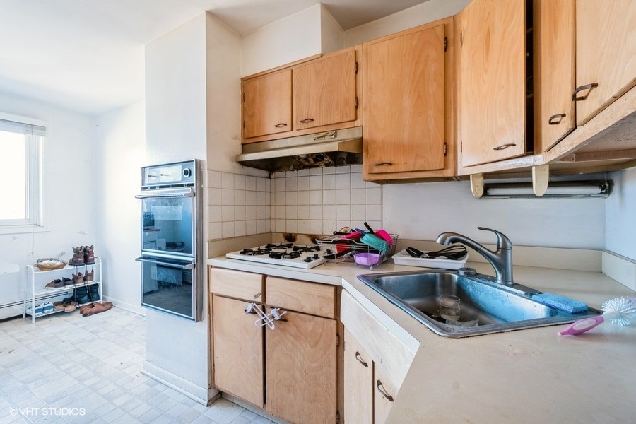 1925 Harrison Street, Unit 3H Evanston, IL 60201 - Photo 7 of 9 a kitchen with a sink stove and cabinets