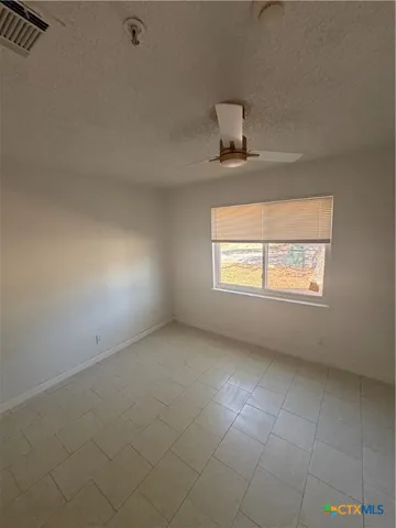 an empty room with a empty space and windows