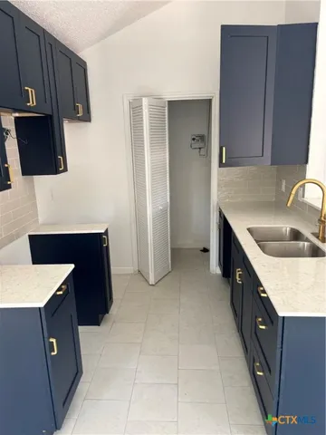 a kitchen with stainless steel appliances a microwave and refrigerator