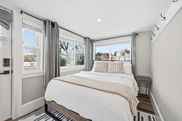 a bedroom with a large bed and a window