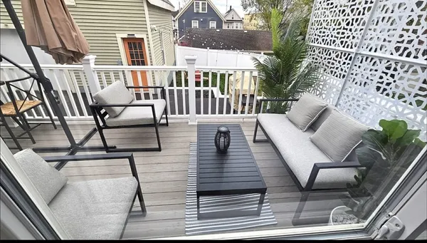 a view of a patio with couches table and chairs and potted plants