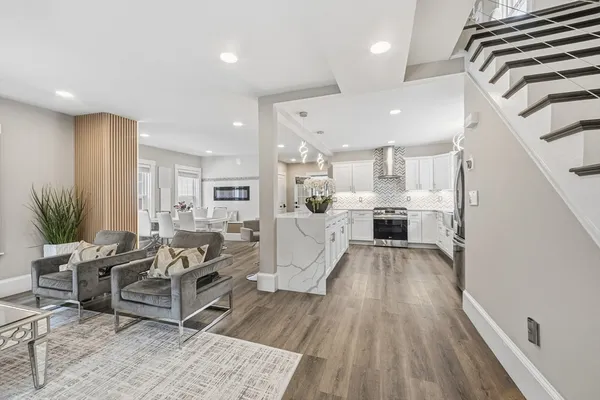a living room with furniture and a wooden floor