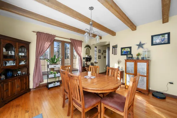 a dining room with furniture and window
