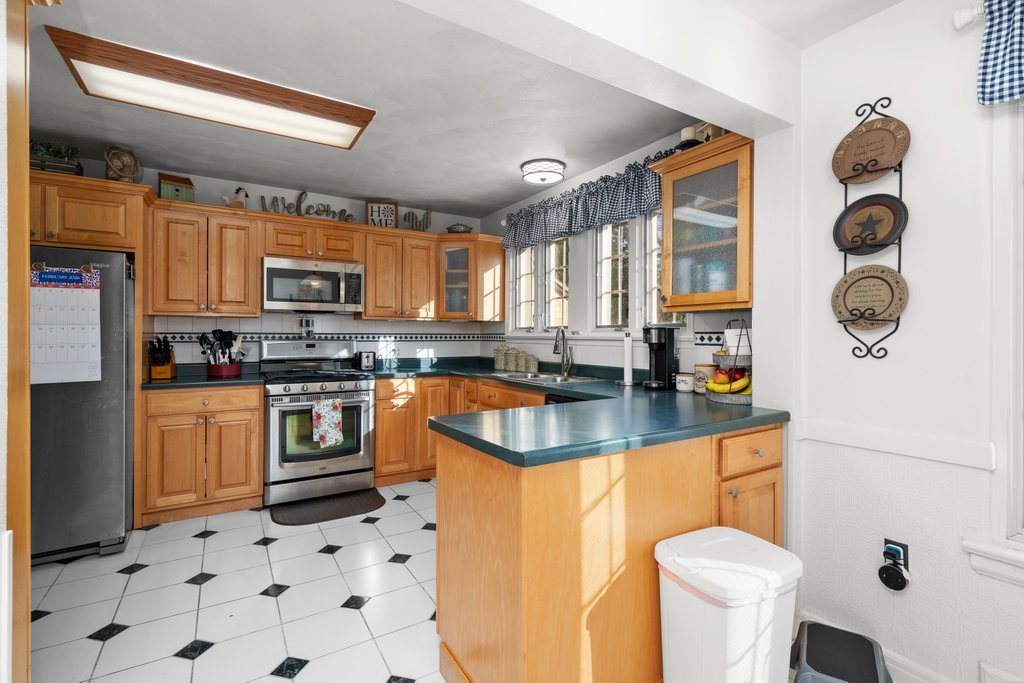 215 West Prospect Street Kewanee, IL 61443 - Photo 19 of 53 a kitchen with stainless steel appliances a stove a sink a microwave a refrigerator and cabinets